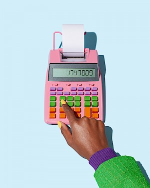 womans hand on calculator on bright background photographed by best studio photographers in London Ilka & Franz represented by Horton Stephens photography ltf