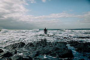 James Bowden, UK  photographer, represented by Horton-Stephens photographer’s agents specialises in natural and authentic  lifestyle outdoors nature photographic images, this colour photo of shows surfing in Cornwall