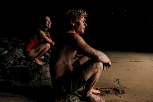 This colour photo shows models in a cave by James Bowden, UK  photographer, represented by Horton-Stephens photographer’s agents specialises in natural and authentic  lifestyle outdoors nature photographic images.