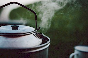 This colour photo shows outside cooking by James Bowden, UK  photographer, represented by Horton-Stephens photographer’s agents specialises in natural and authentic  lifestyle outdoors nature photographic images.