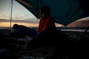 This colour photo shows a sunset landscape camping scene by James Bowden, UK  photographer, represented by Horton-Stephens photographer’s agents specialises in natural and authentic  lifestyle outdoors nature photographic images.